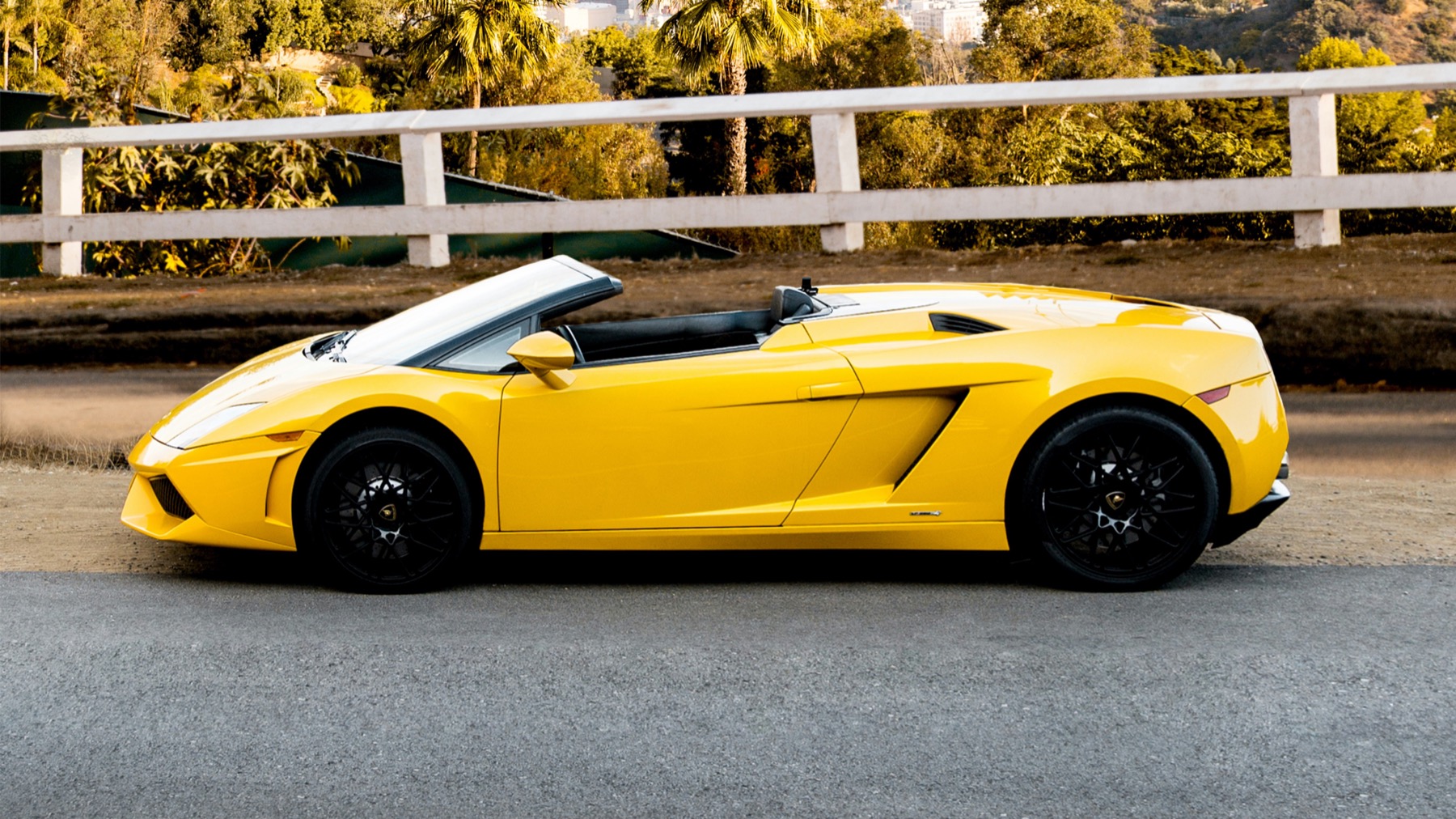 Complete yellow exotic automobile shown from bumper to bumper